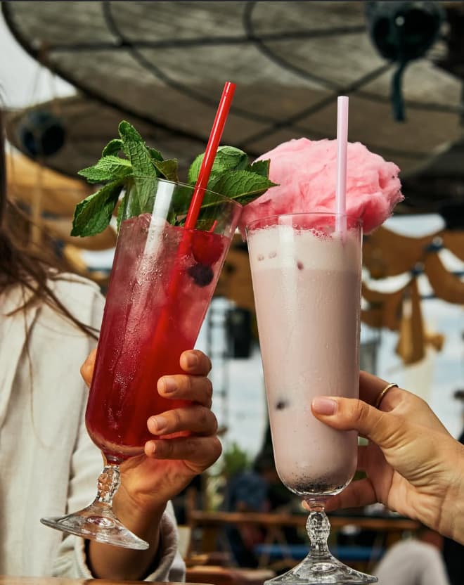 Cócteles tropicales y coloridos servidos en la terraza frente al mar en Astral